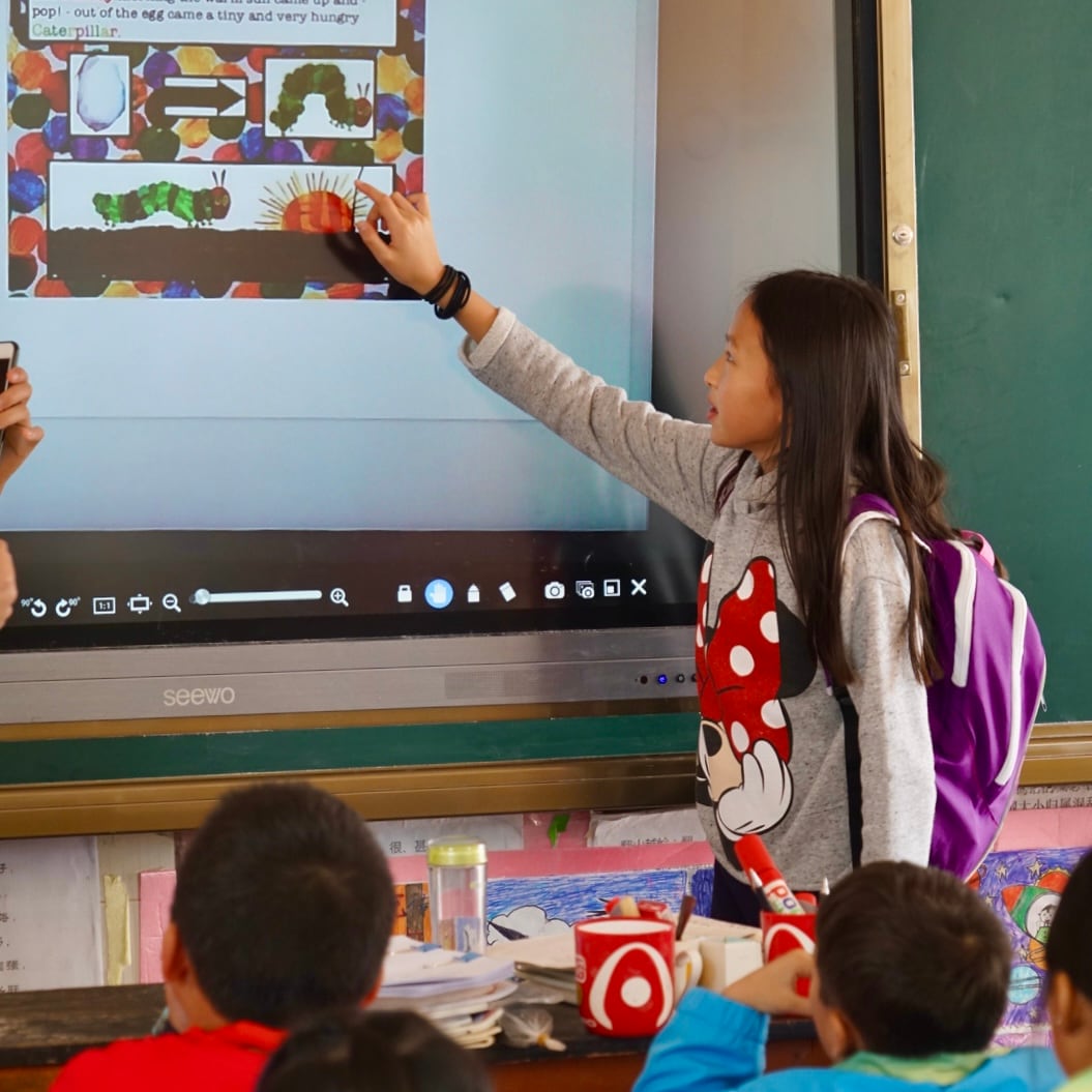 A young Sonia Shum presents a caterpillar lesson to elementary students.
