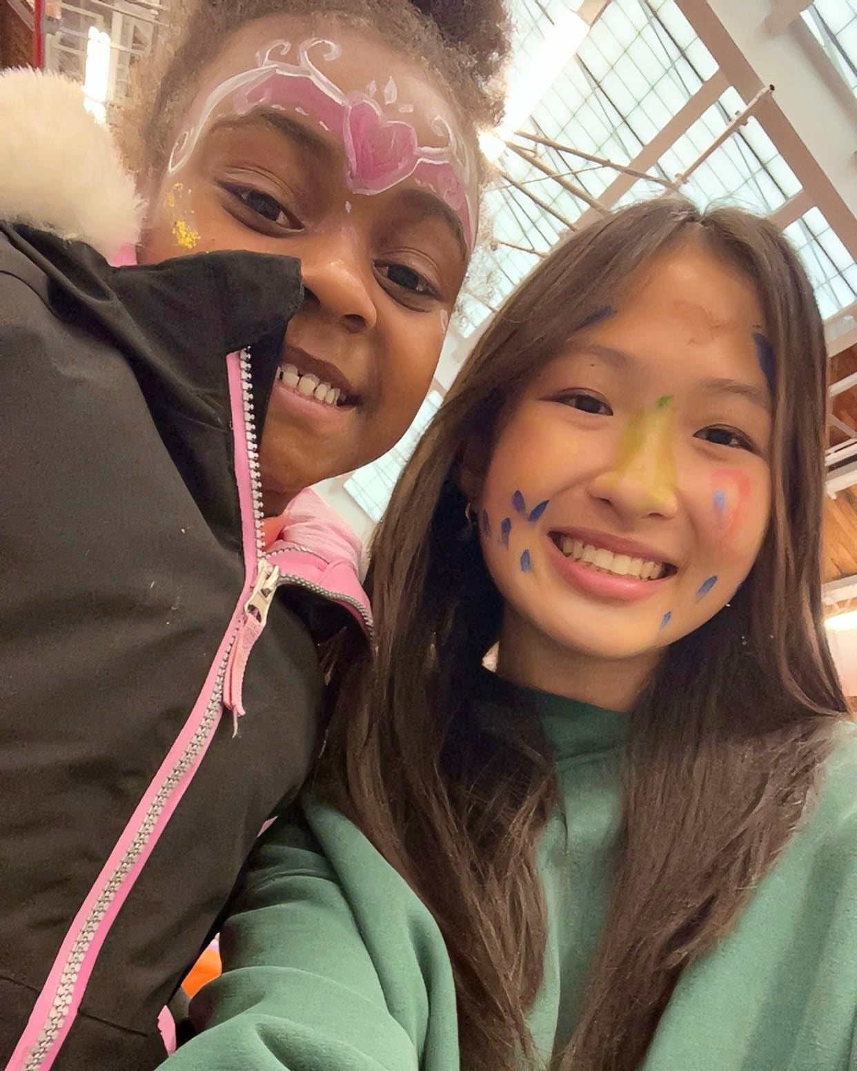 Sonia Shum smiles with a student during a high school outreach activity.