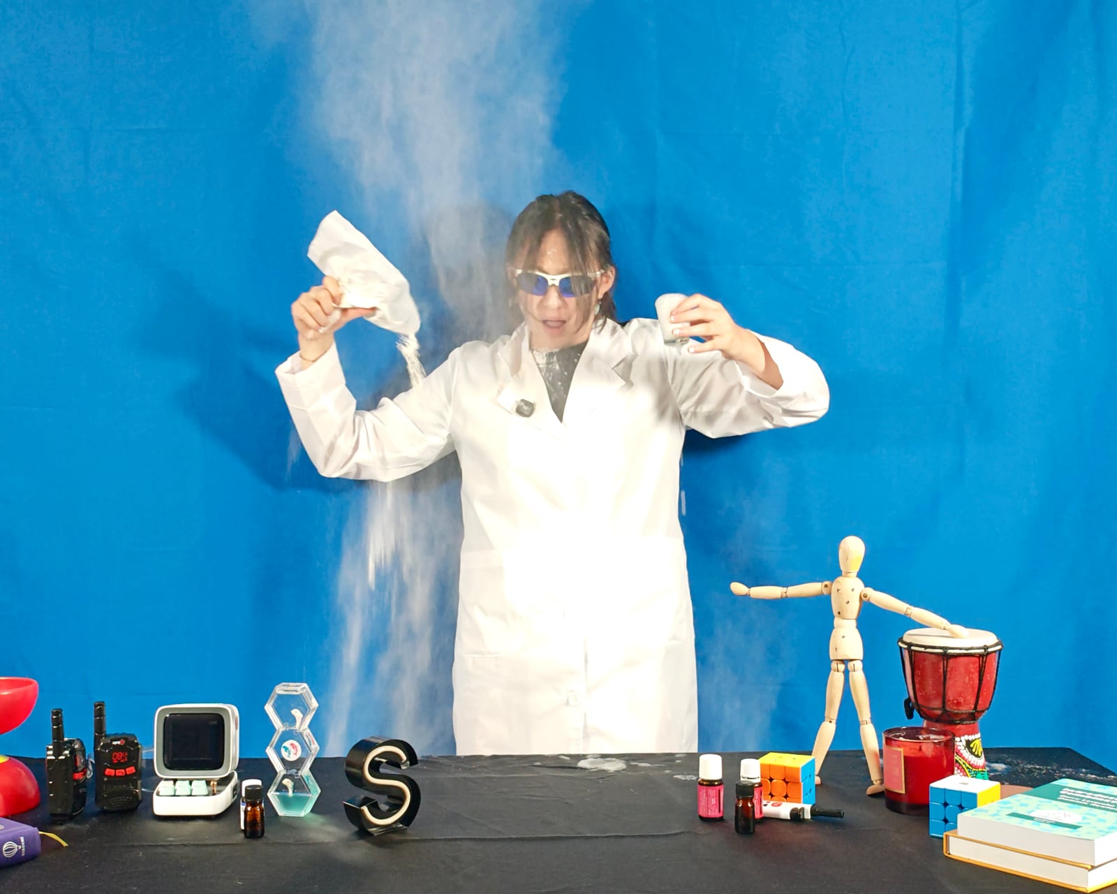 Sonia Shum performs a science experiment while filming a Lab-a-cadabra video.